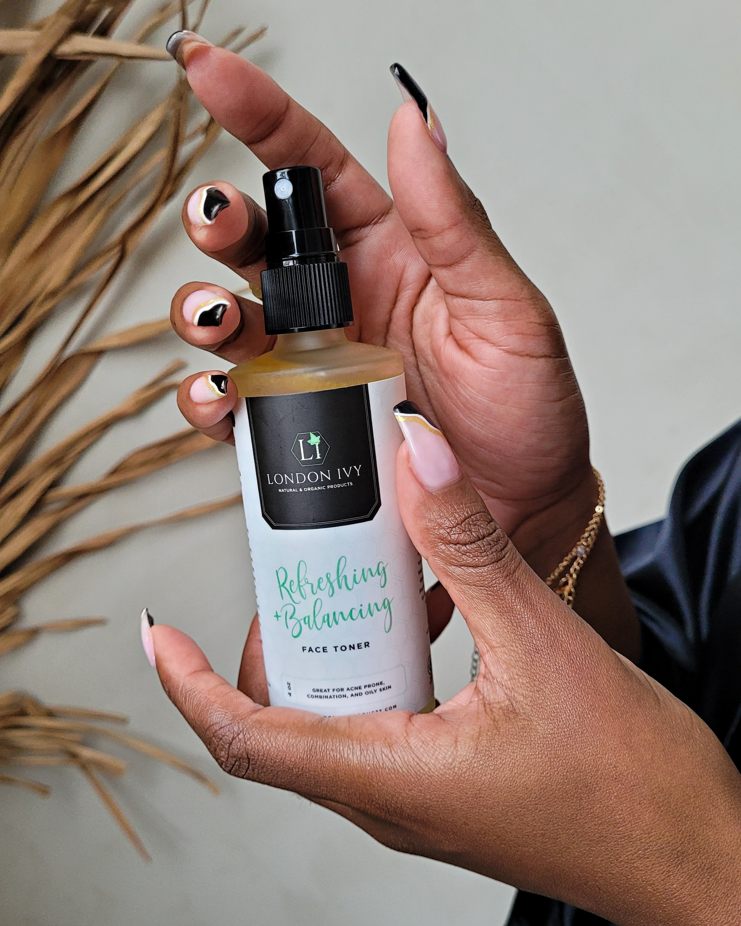 Refreshing and balancing toner being held for display in a bathroom